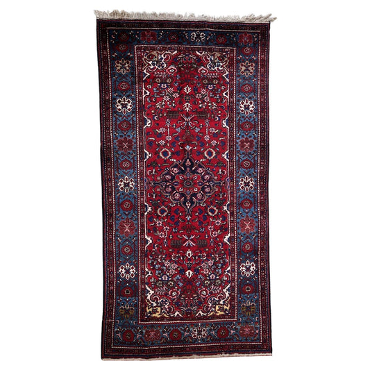 Handmade Vintage Persian Malayer Rug - 1960s - Dominant hues of red, green, orange, and navy blue with intricate geometric designs