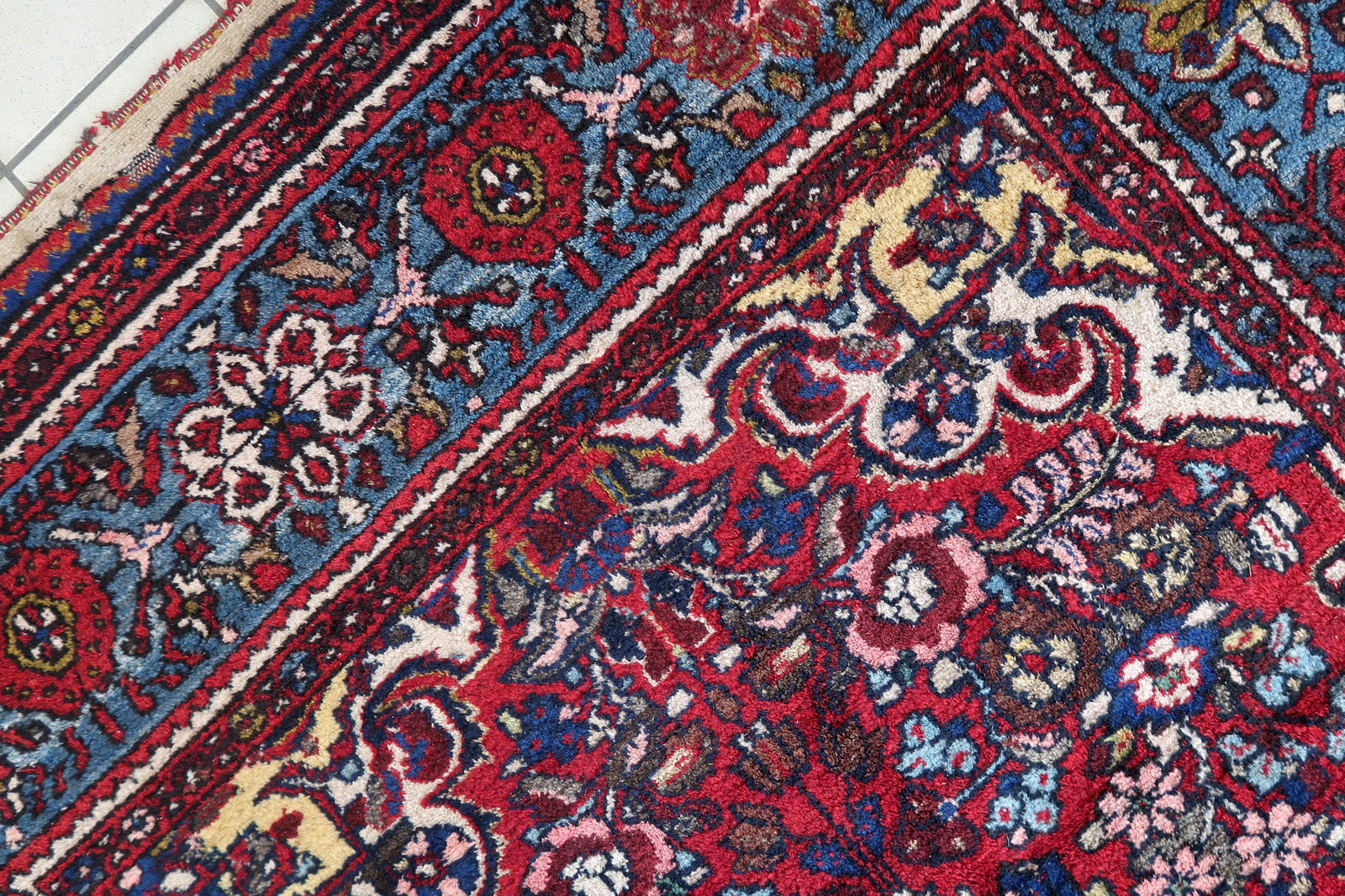 Close-up of red hues on Handmade Vintage Persian Malayer Rug - Detailed view highlighting the vibrant red colors.