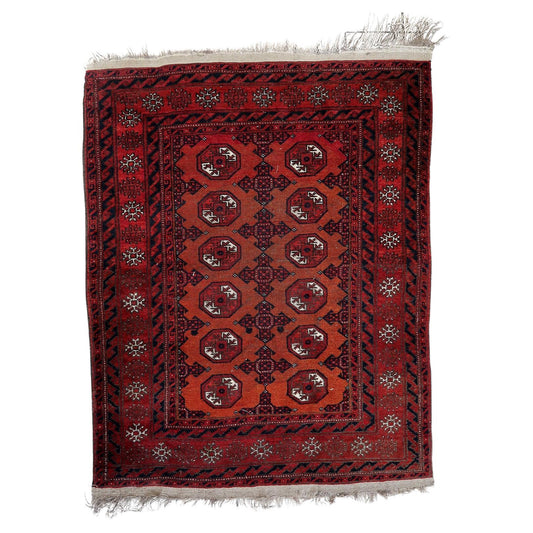 Handmade Antique Afghan Baluch Rug - 1920s - Compact yet impactful with dominant red hue and intricate geometric designs.