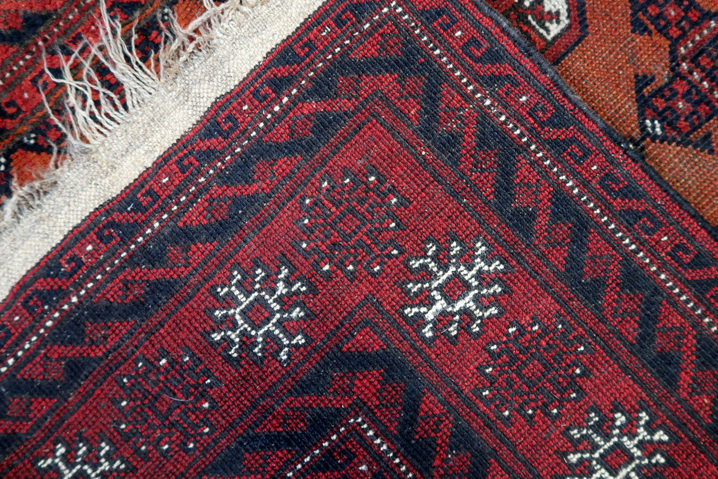 Back side of the Handmade Antique Afghan Baluch Rug - Underside view revealing the rug's construction and material
