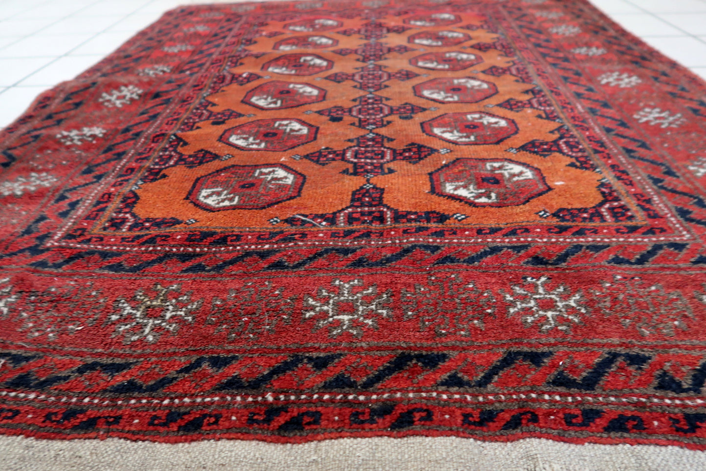 Close-up of traditional motifs on Handmade Antique Afghan Baluch Rug - Detailed view highlighting the traditional motifs, including diamonds and stars.