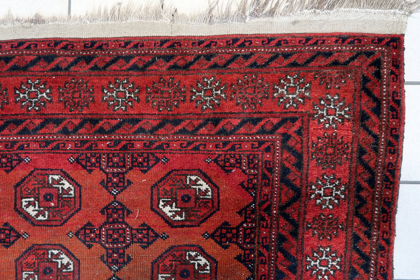 Close-up of geometric designs on Handmade Antique Afghan Baluch Rug - Detailed view showcasing the intricate geometric patterns, including diamonds and stars.