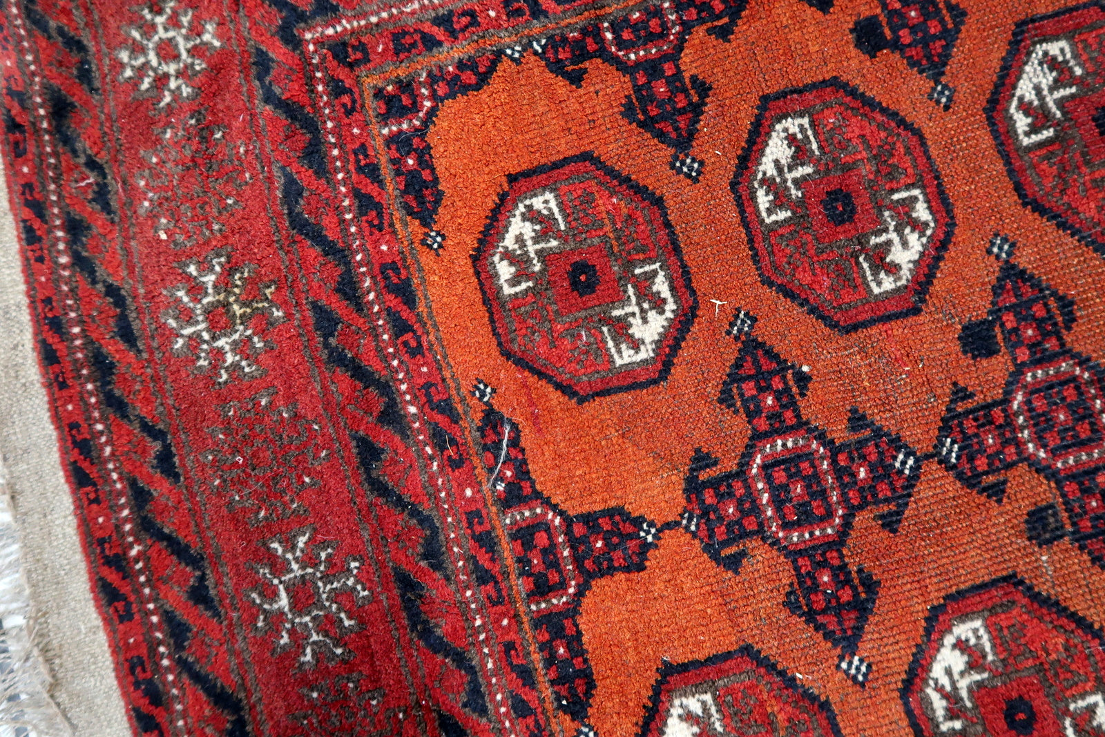 Close-up of intricate patterns on Handmade Antique Afghan Baluch Rug - Detailed view showcasing the intricate geometric designs, adding to the rug's appeal.