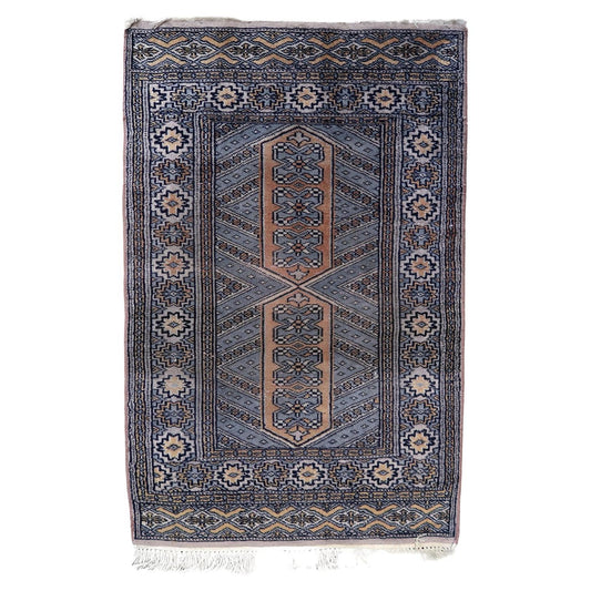 Vintage Uzbek Bukhara rug with red field and gul medallions

