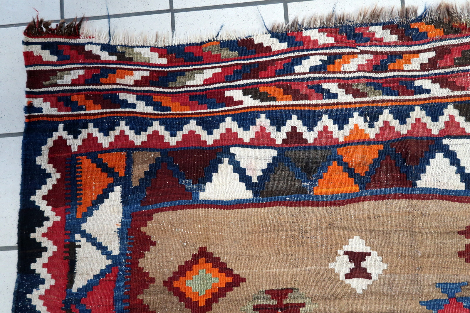 Handwoven Persian flatweave rug with tribal motifs

