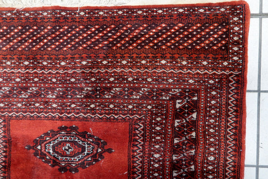 Handmade 1950s wool rug in deep red

