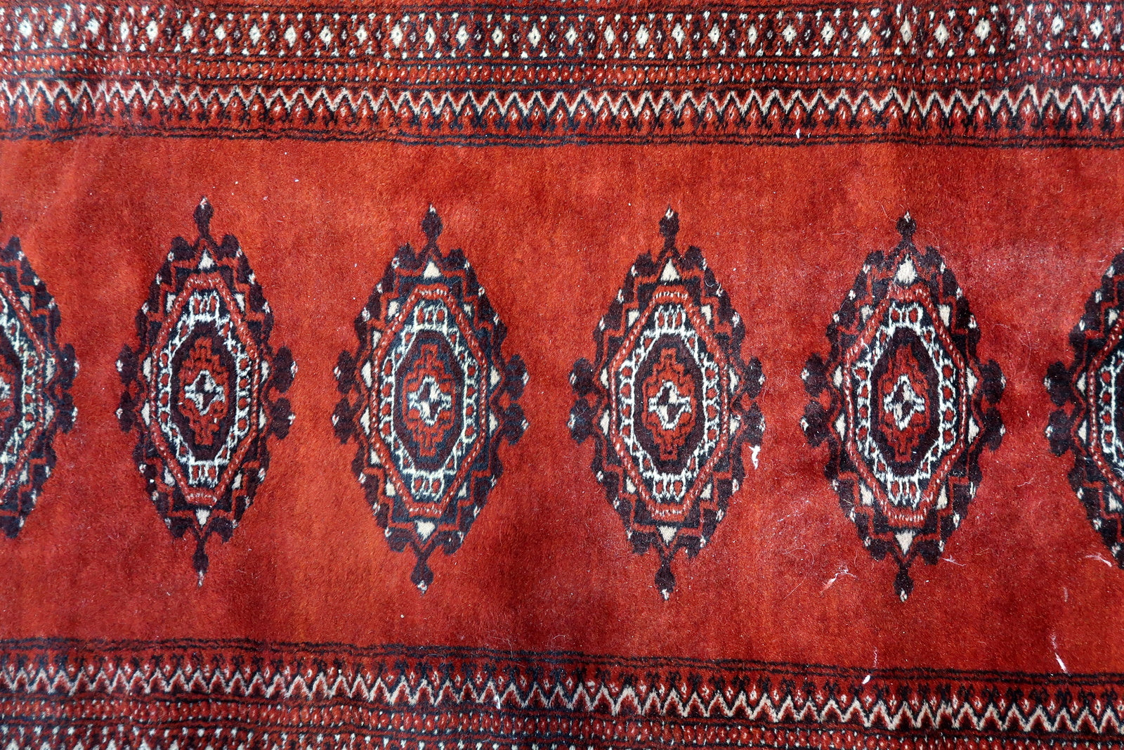 Detail of traditional gul pattern in dark blue and cream

