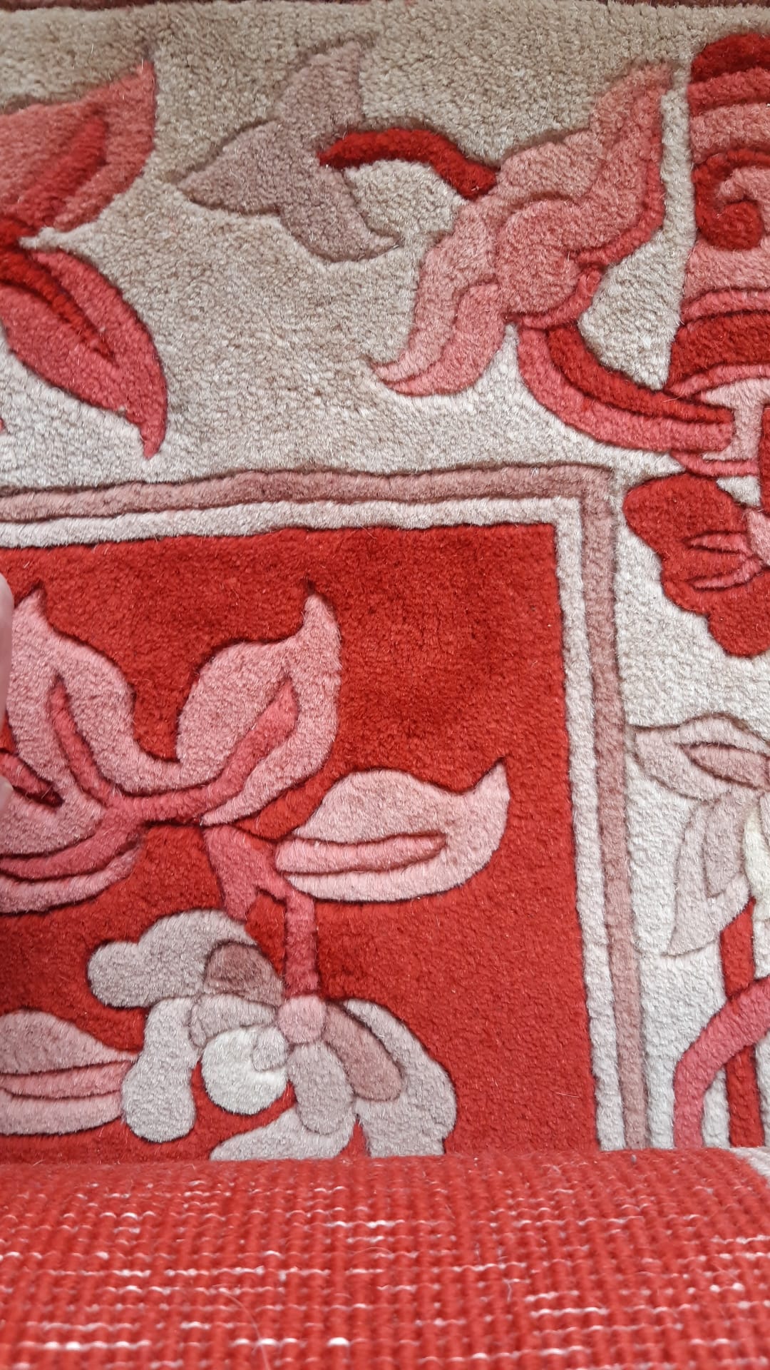 Close-up of floral design on vintage Chinese wool rug
