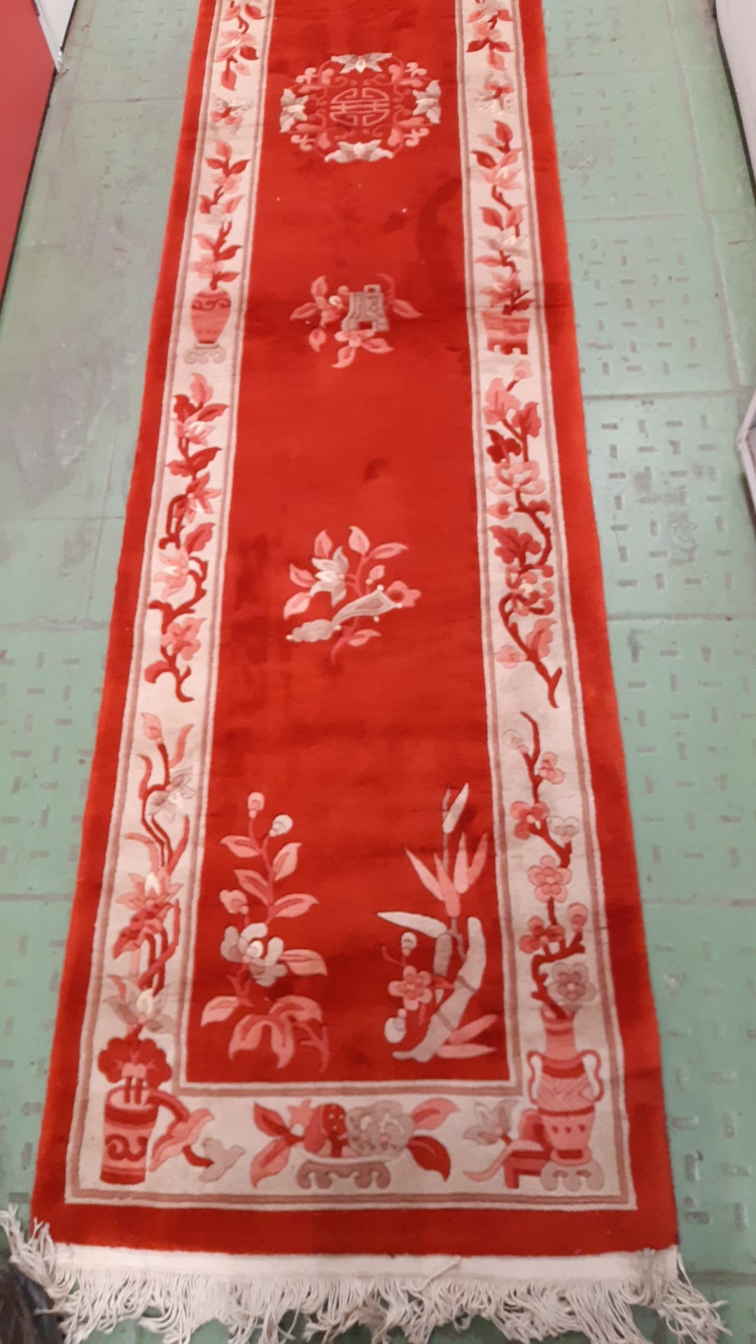 Side view of vintage wool rug with floral patterns
