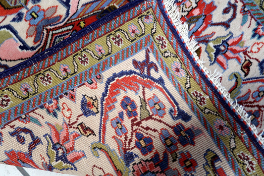 Close-up of the hand-knotted wool texture on this 1950s Persian rug
