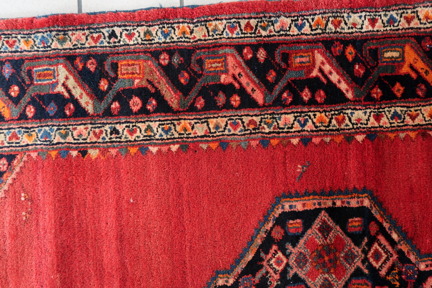 Earthy brown and deep orange shades in the border design.

