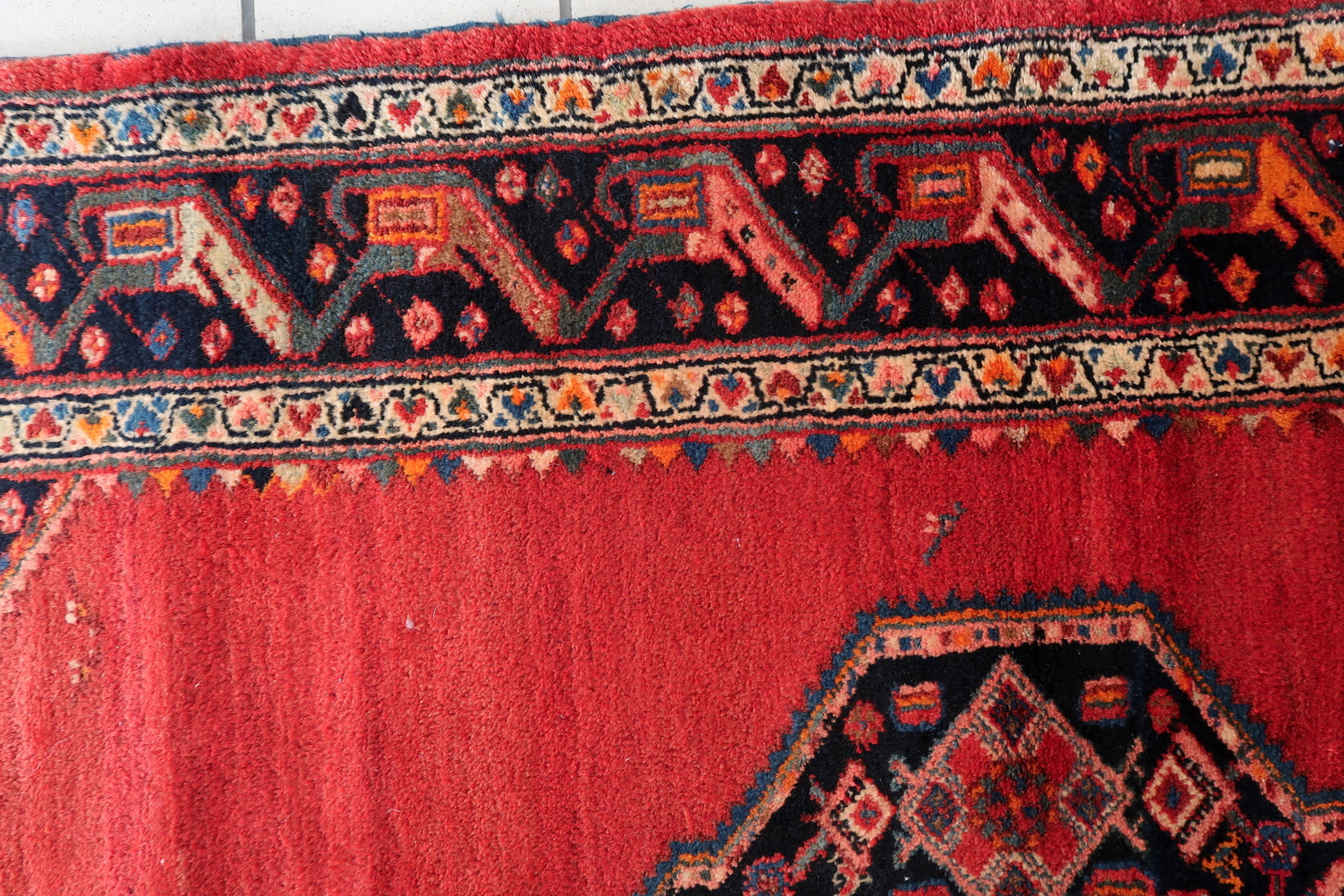 Earthy brown and deep orange shades in the border design.

