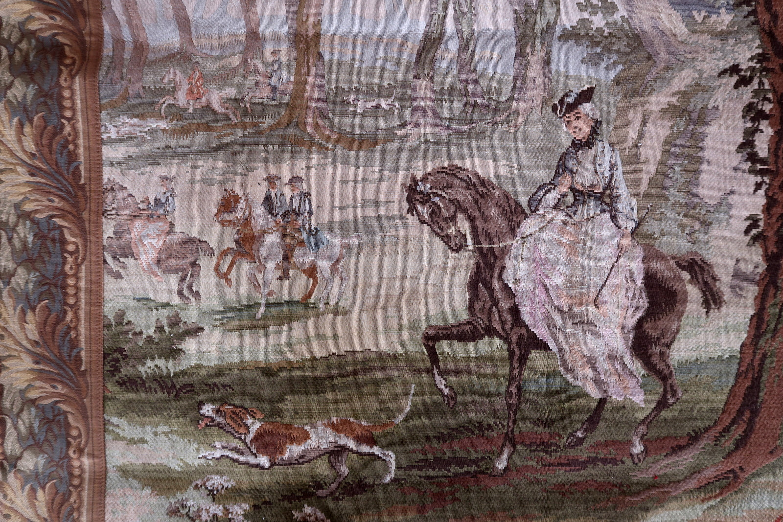 Contrast between the red riding coats and the green forest background.

