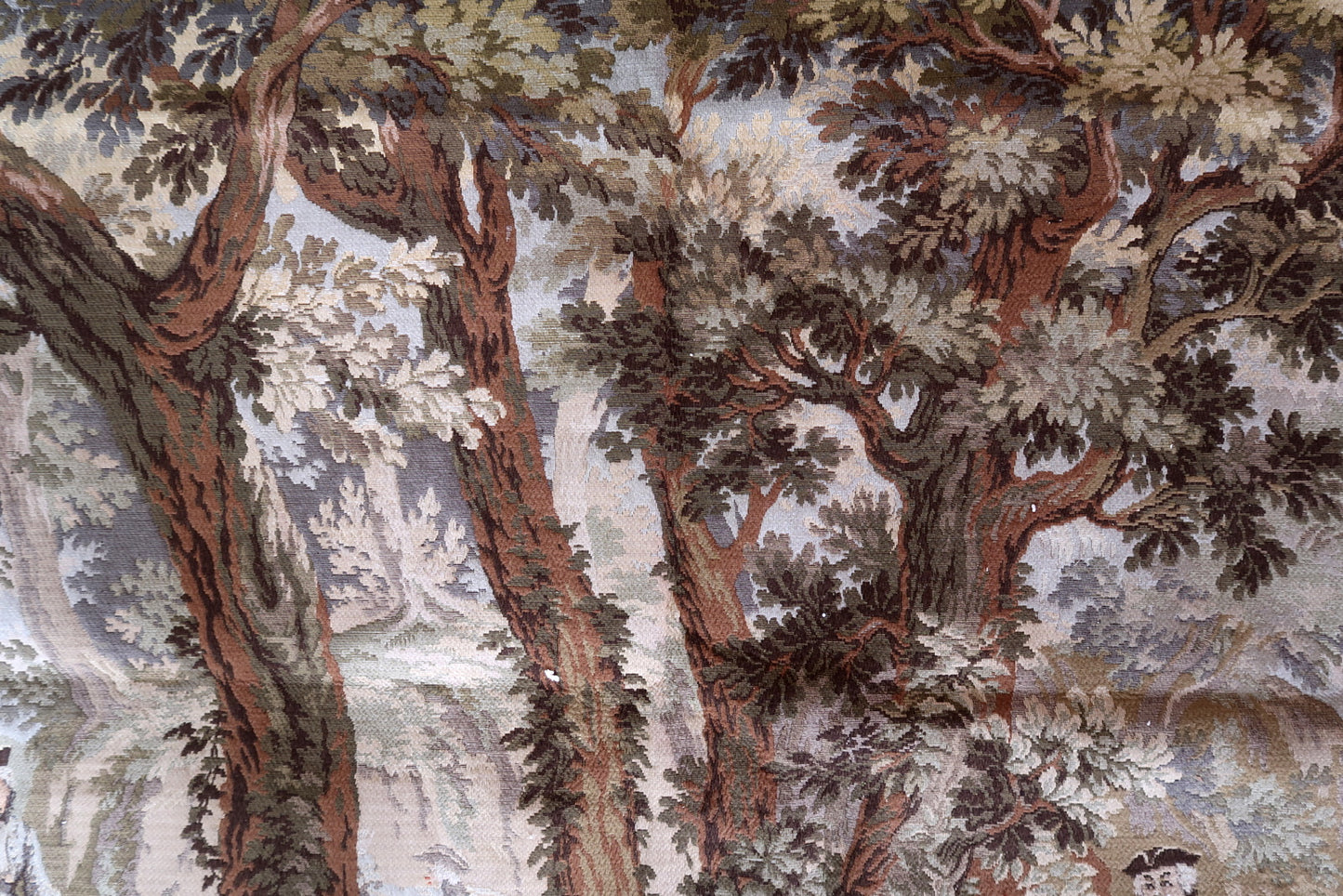 Individual figures and horses woven with intricate detail.

