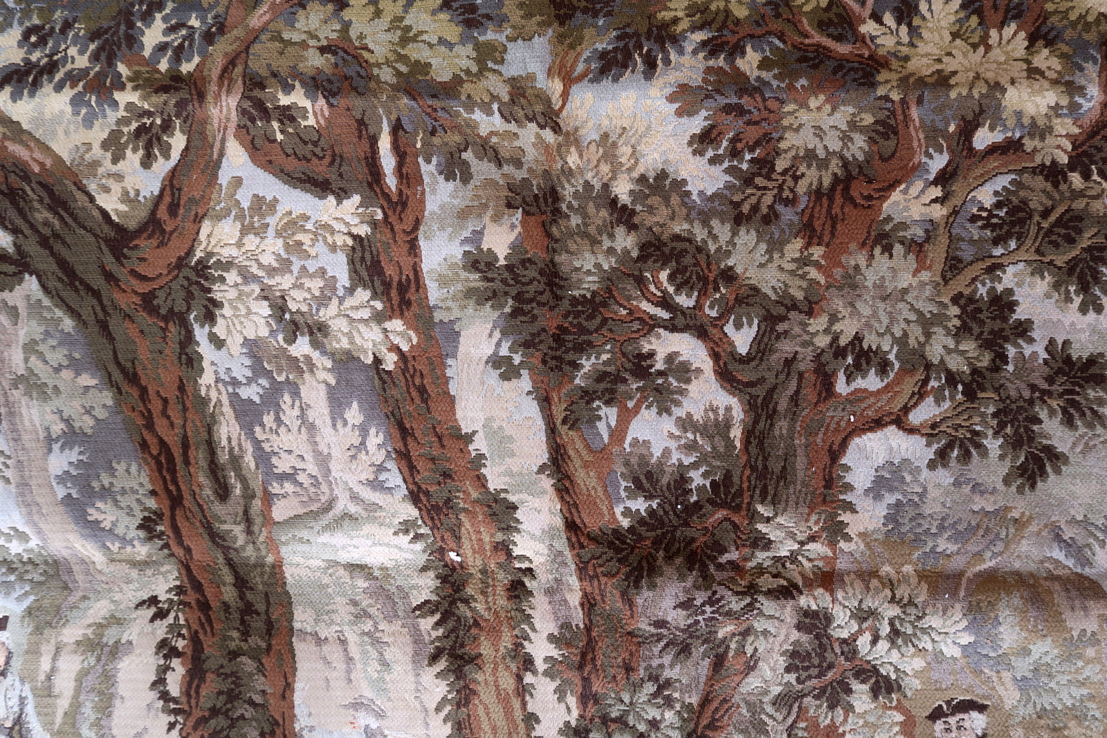 Individual figures and horses woven with intricate detail.

