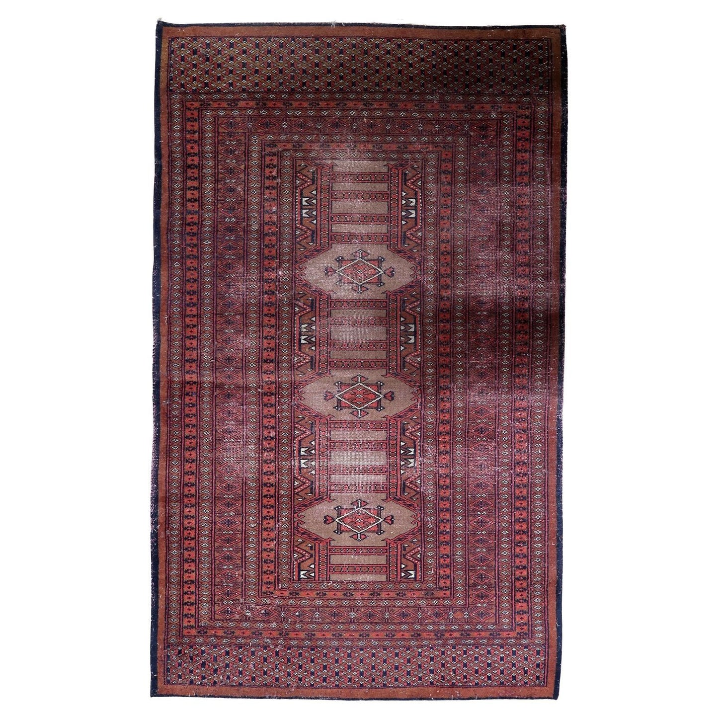 Vintage Uzbek Bukhara rug with repeating gul medallions on a deep red field.

