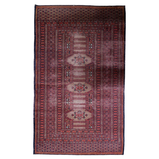 Vintage Uzbek Bukhara rug with repeating gul medallions on a deep red field.

