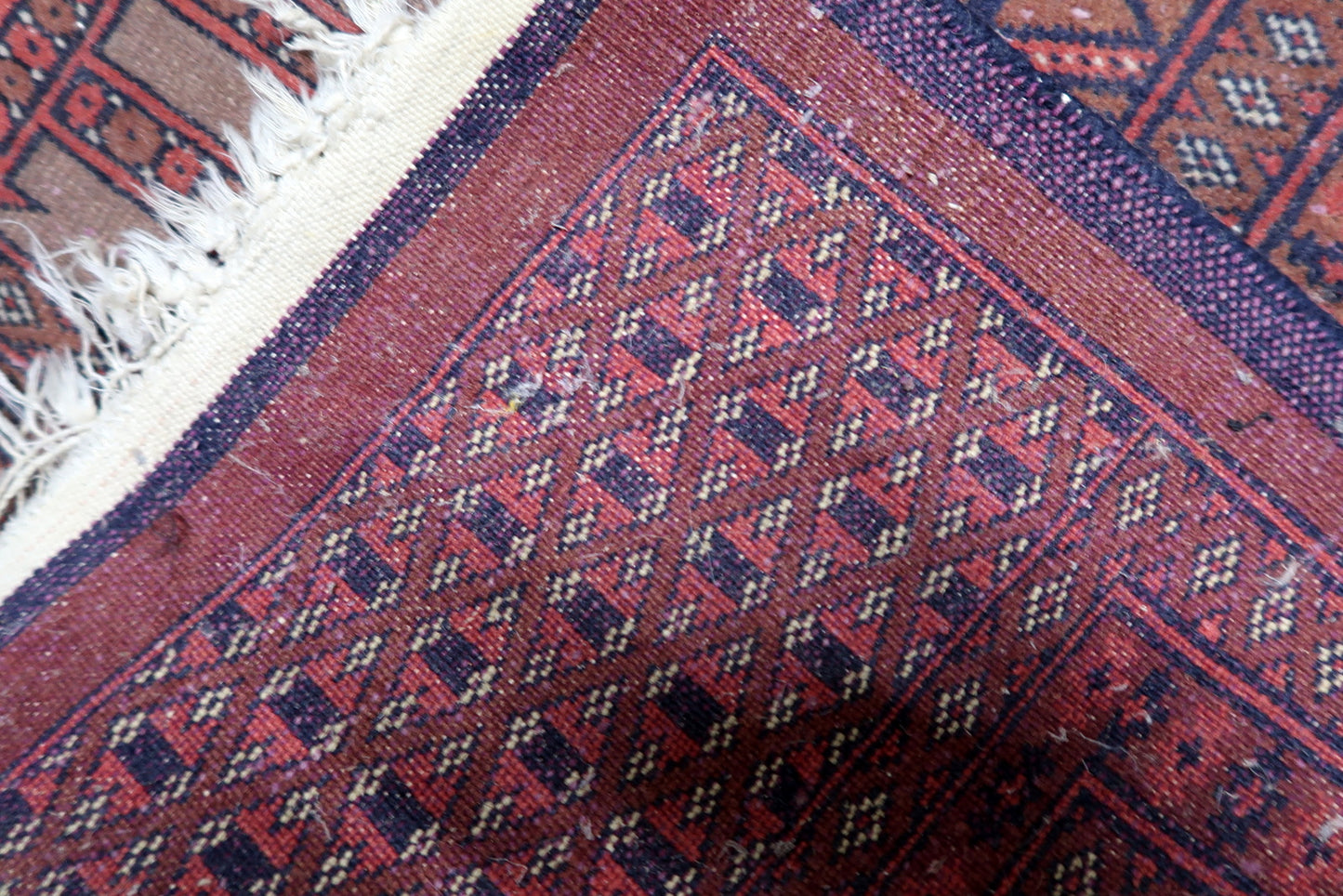 Deep, saturated colors of the rug in natural lighting.


