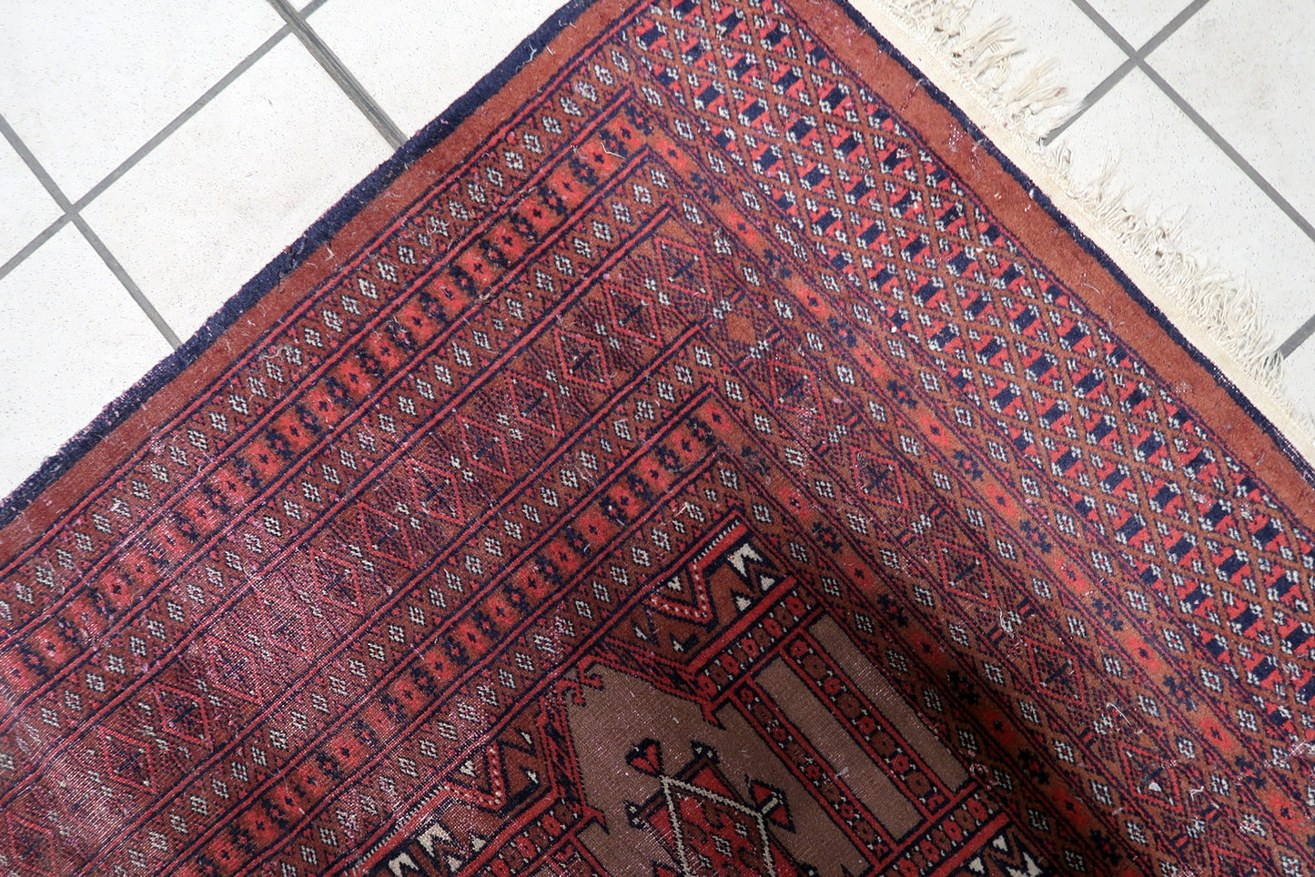 Textured low pile surface of the hand-knotted wool Bukhara rug.

