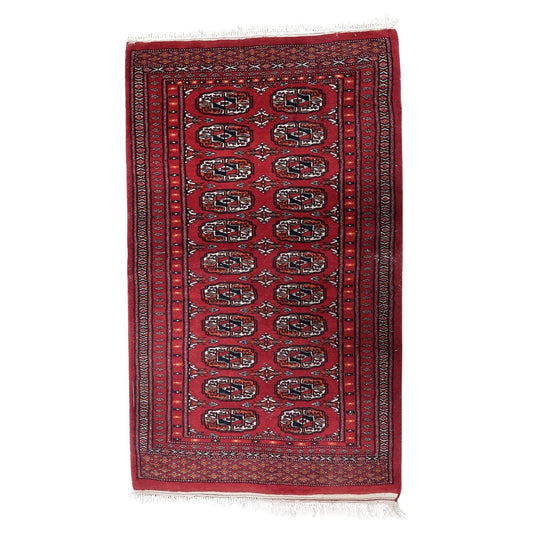 Vintage Uzbek Bukhara runner with repeating geometric gul motifs.

