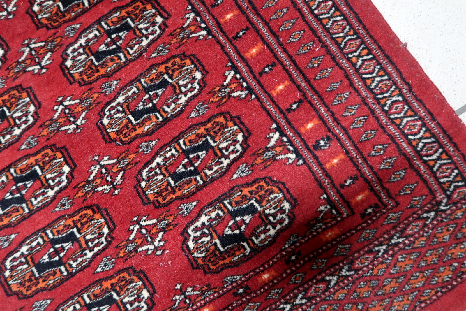 Terracotta orange and white accents within the geometric designs.


