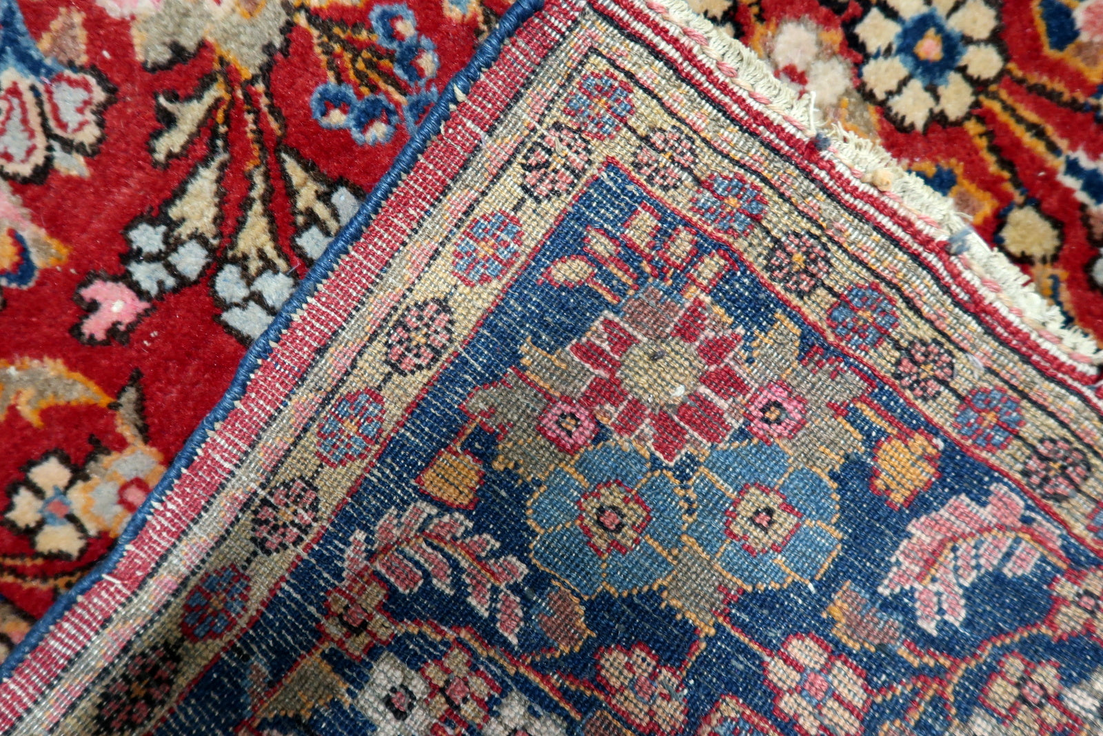 Rich brick red background color characteristic of Kashan rugs.

