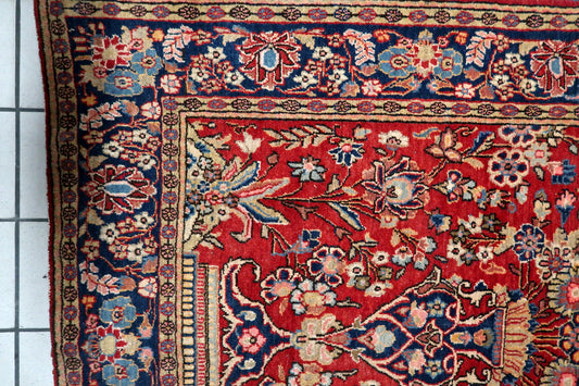 Close-up of the stately vase motif anchoring the floral pattern.