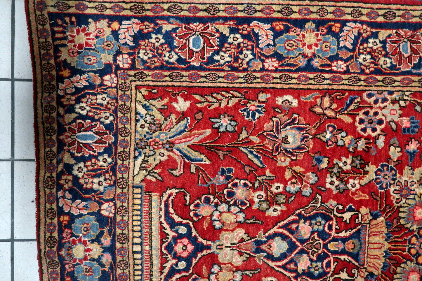 Close-up of the stately vase motif anchoring the floral pattern.

