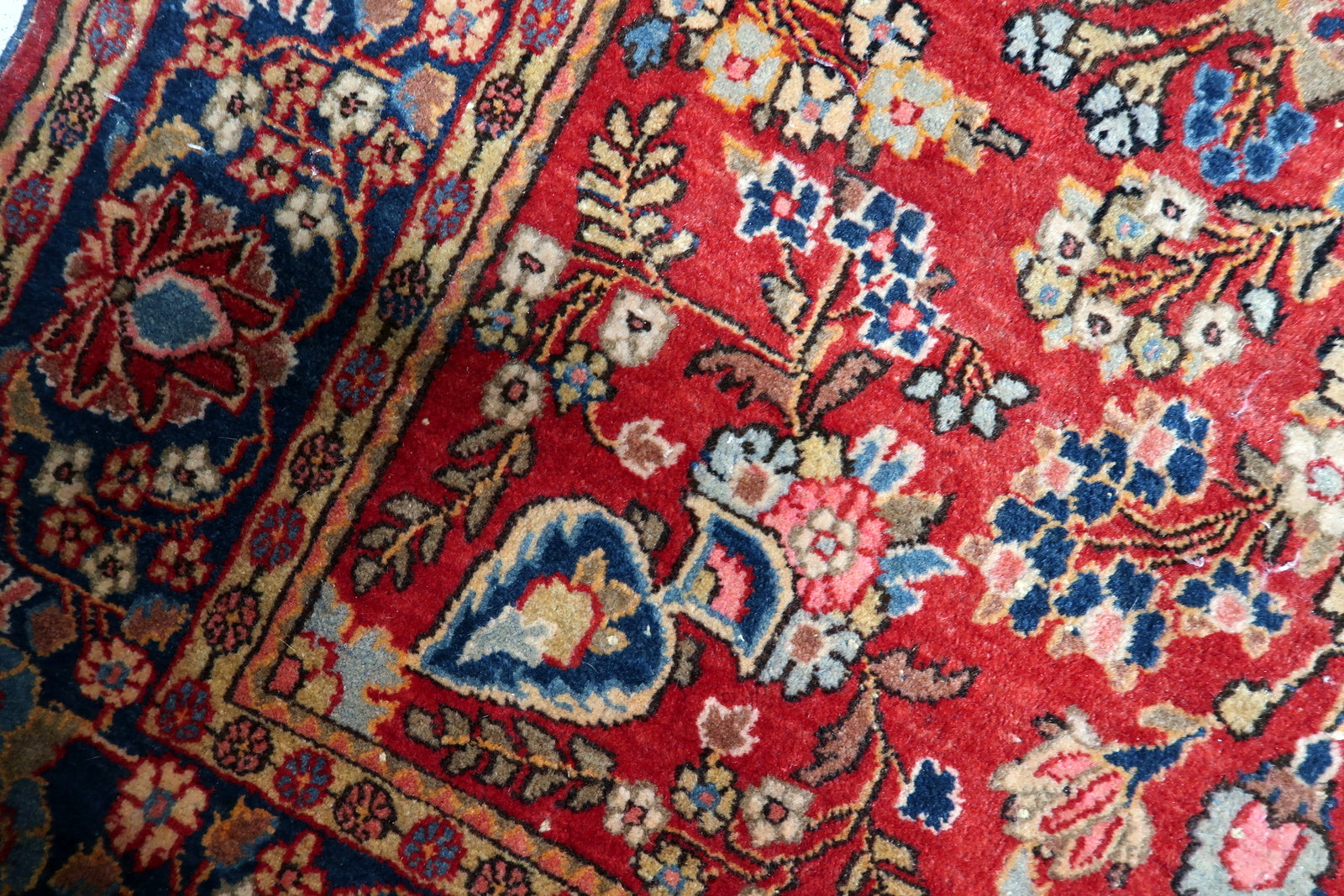 Contrast between the brick-red field and the navy blue border.

