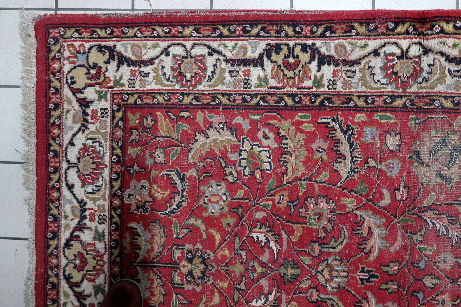 Close-up of floral and botanical motifs on rich red background

