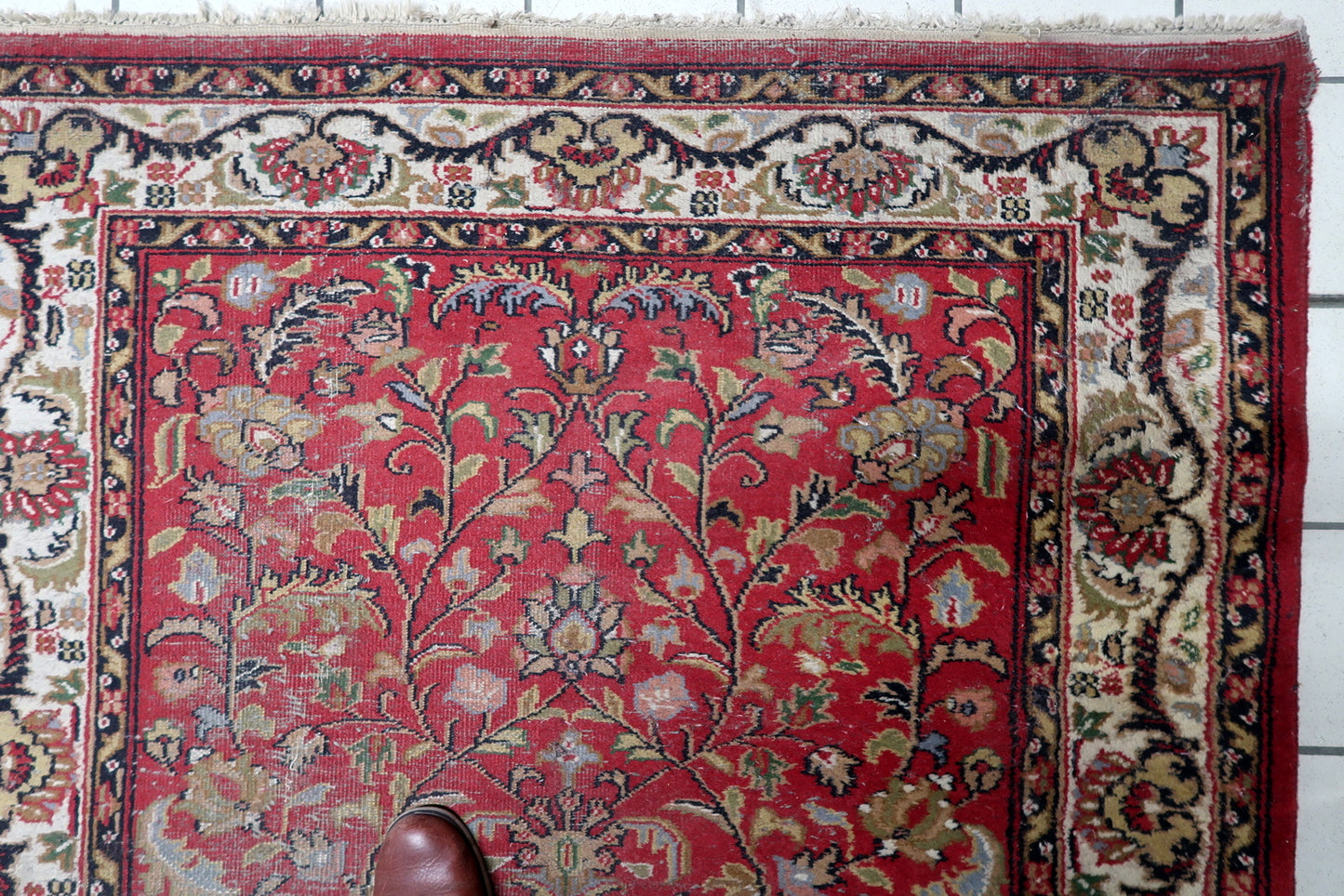 Worn low pile texture showing the rug's aged character

