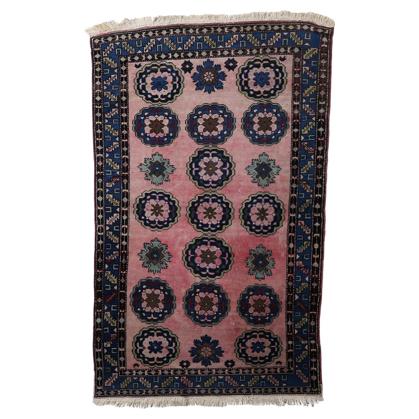 Vintage Malayer rug with oversized floral medallions on pink background

