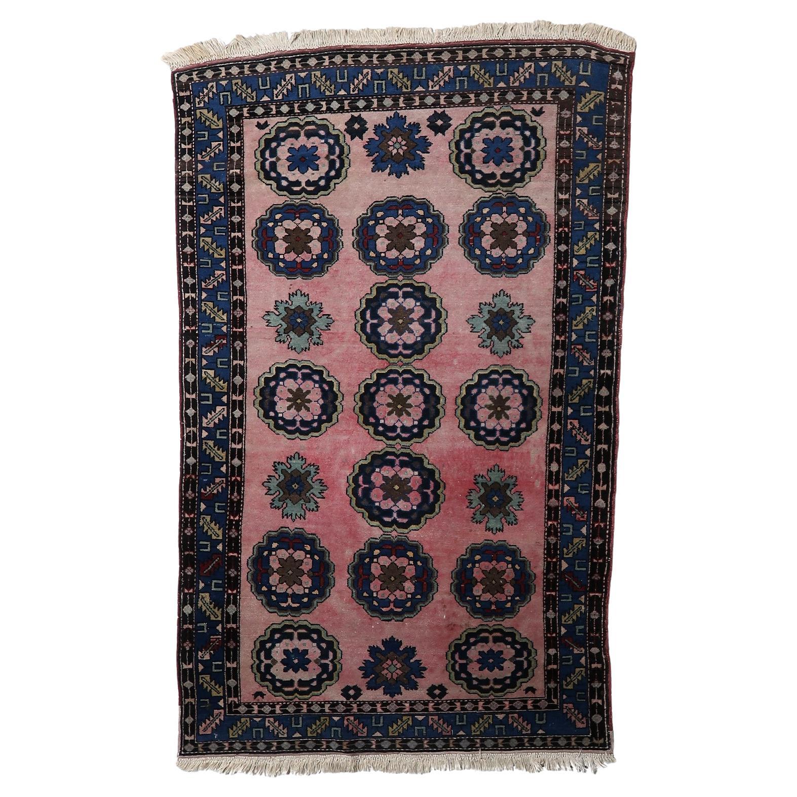 Vintage Malayer rug with oversized floral medallions on pink background

