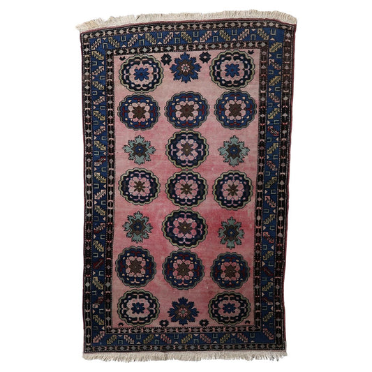 Vintage Malayer rug with oversized floral medallions on pink background

