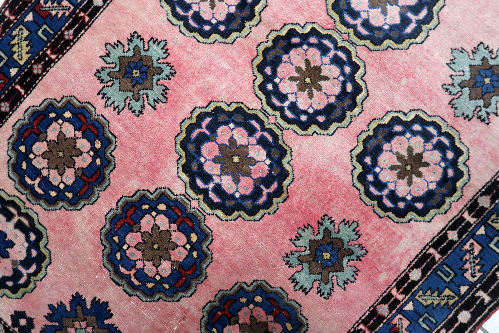 Sky blue and teal elements within the large medallion design

