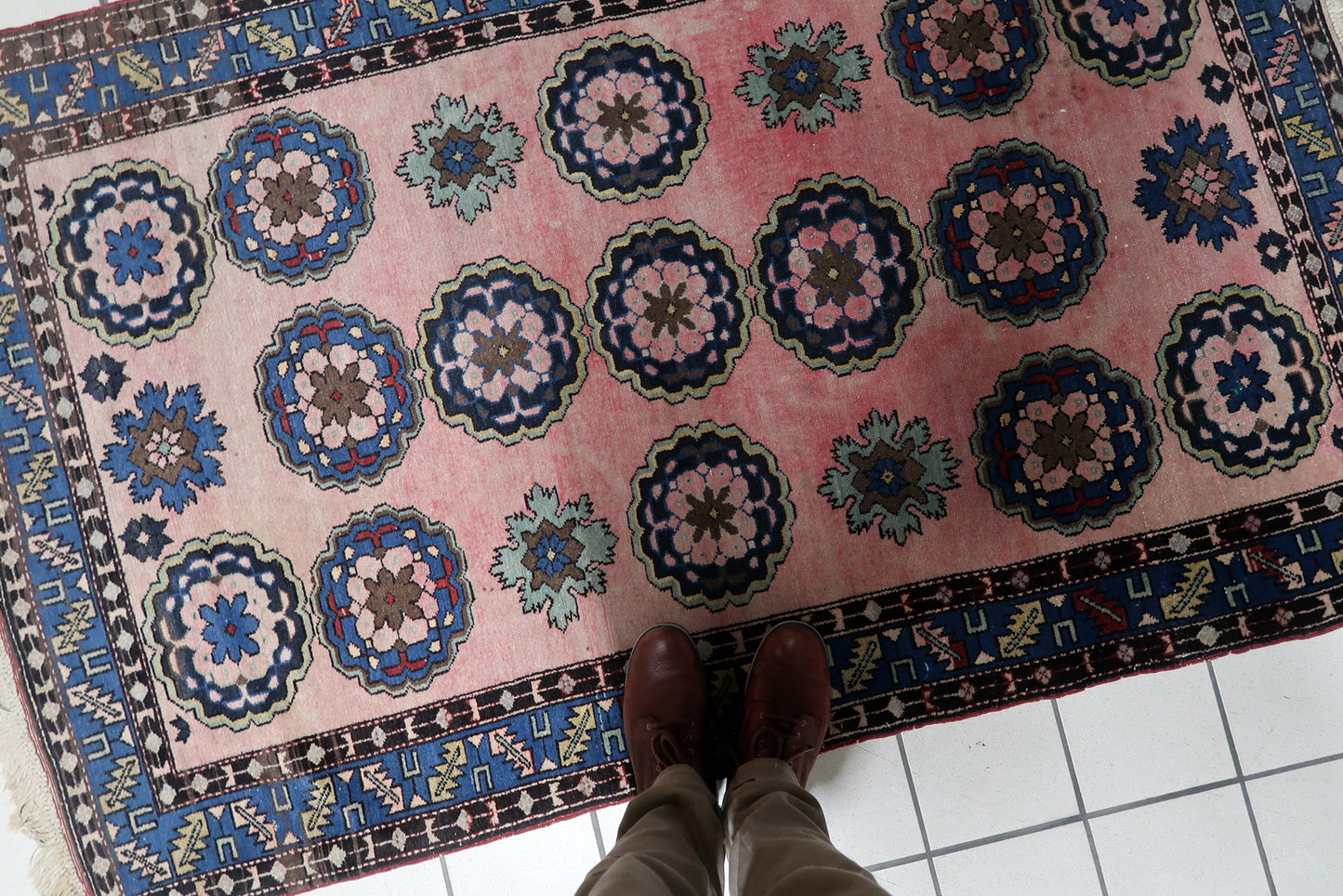 Full rug view showing grid layout of floral motifs


