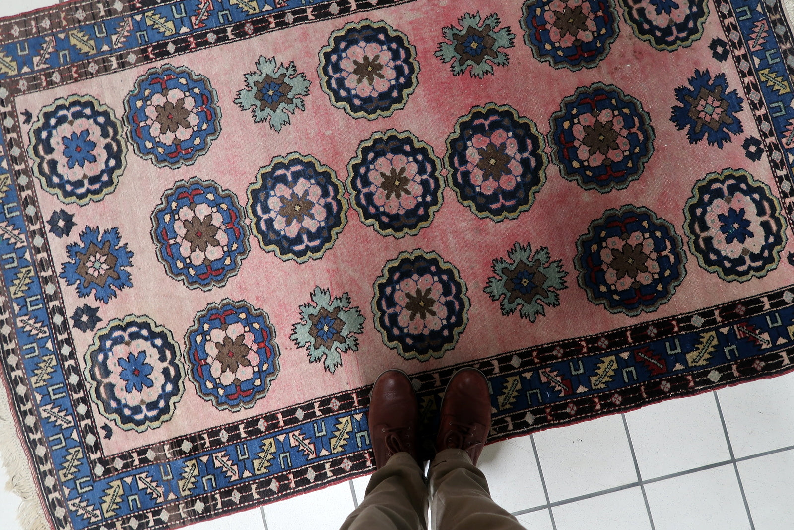 Full rug view showing grid layout of floral motifs


