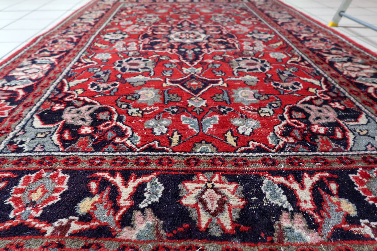 Low pile texture showing the rug's gentle aged wear

