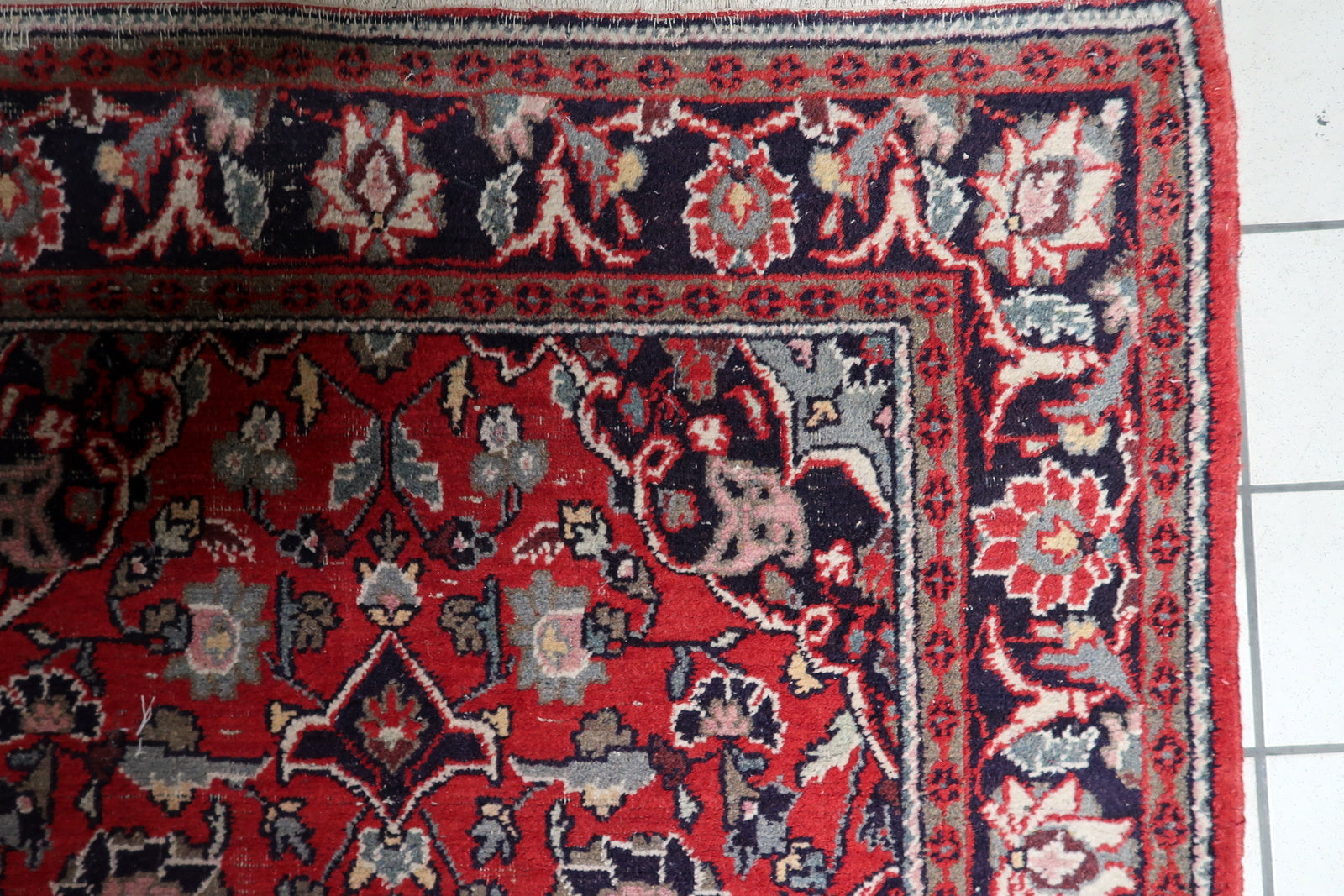 Navy blue botanical patterns on the wide elaborate border

