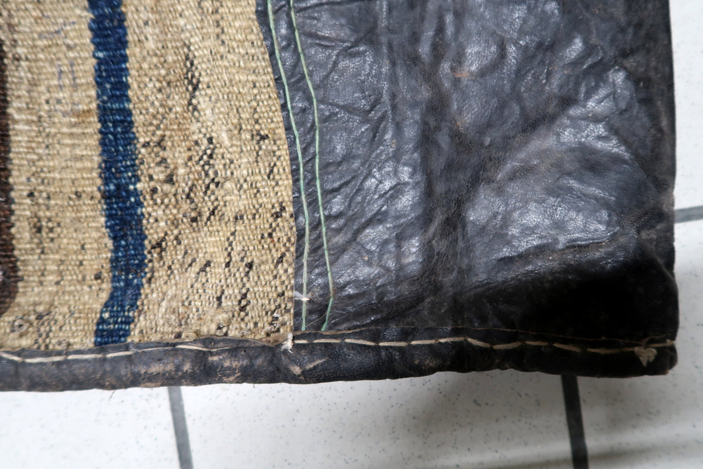 Side view showing wool pile depth and leather edging

