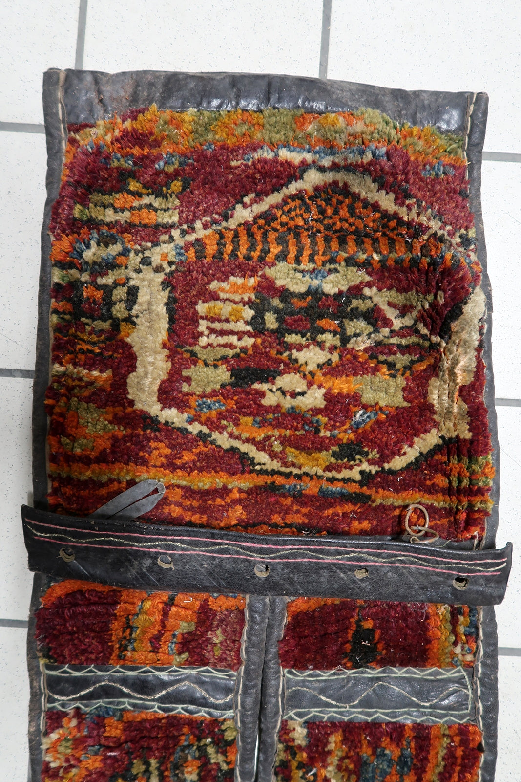 Close-up of geometric tribal motifs in burgundy and orange

