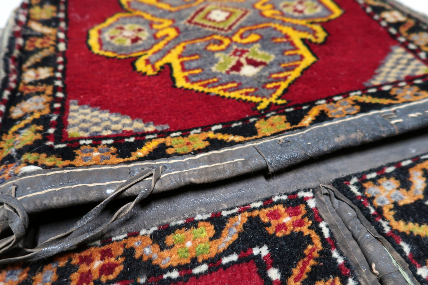 Contrast between red field and black geometric motifs

