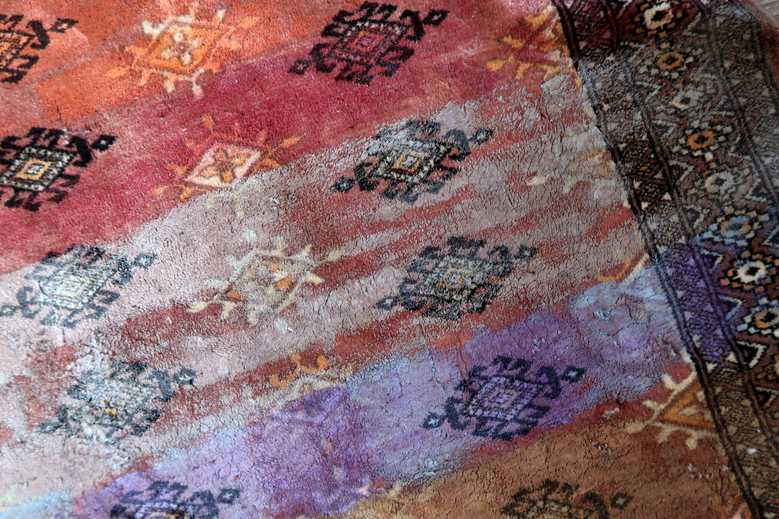 Original Bukhara patterns peeking through artistic overlay

