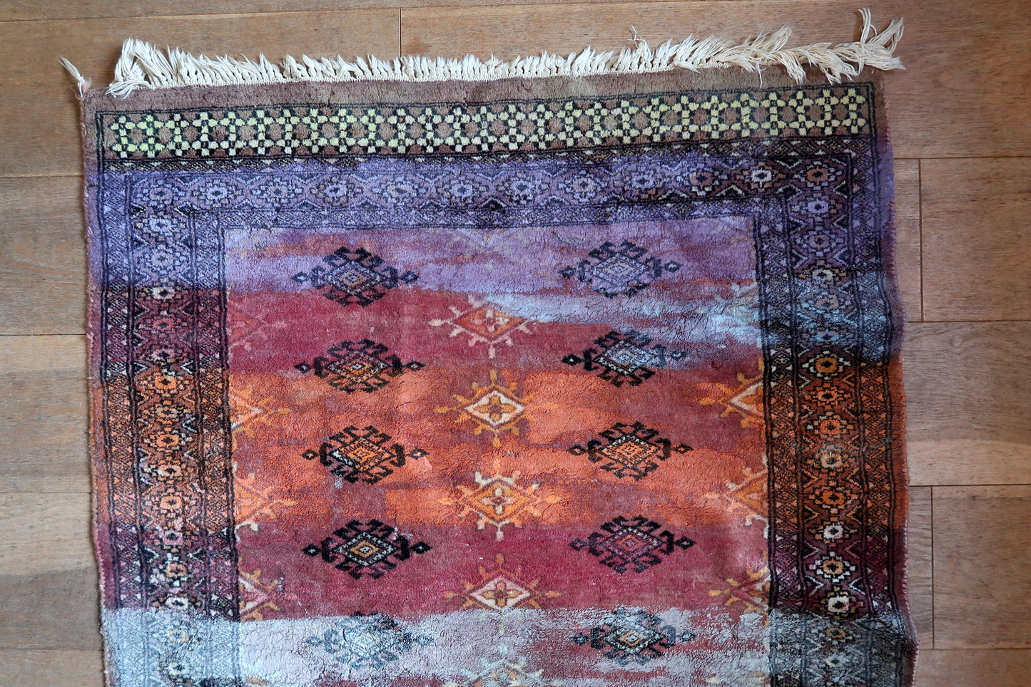 Detailed view where original pattern emerges through paint

