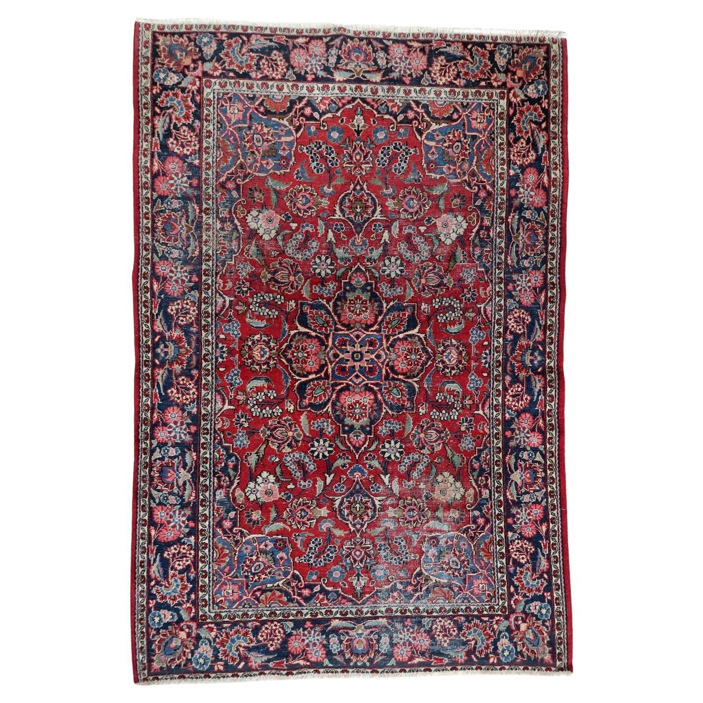 Full top view of the antique Persian Kashan rug showing the central medallion and floral field.

