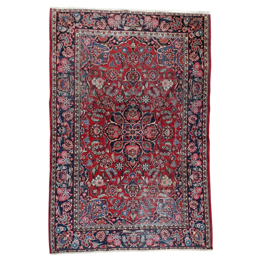 Full top view of the antique Persian Kashan rug showing the central medallion and floral field.

