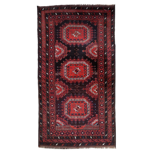 Full top view of the antique Baluch rug showing the complete lattice and geometric pattern.

