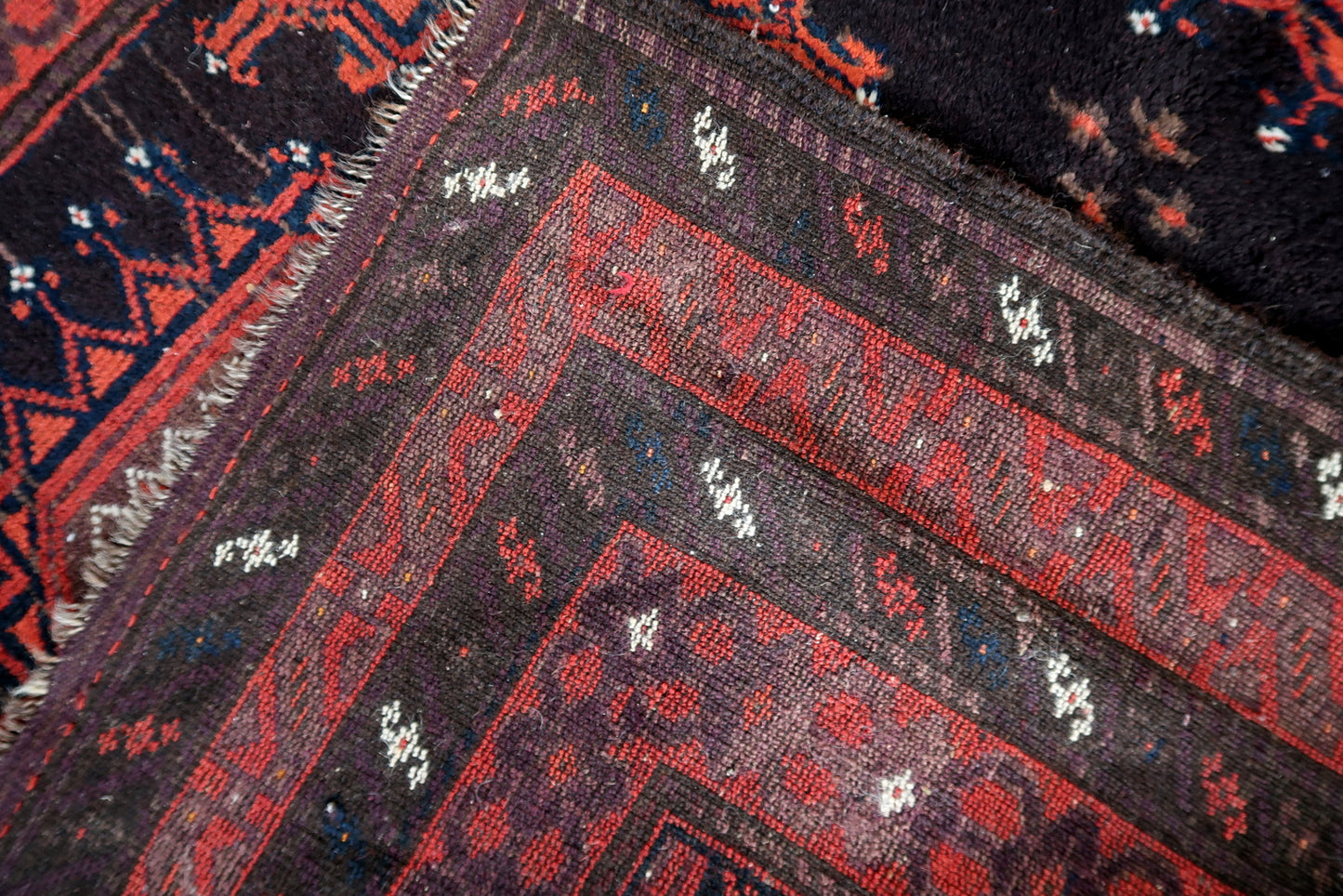 A section of the rug showcasing the repetitive and rhythmic nature of the pattern.

