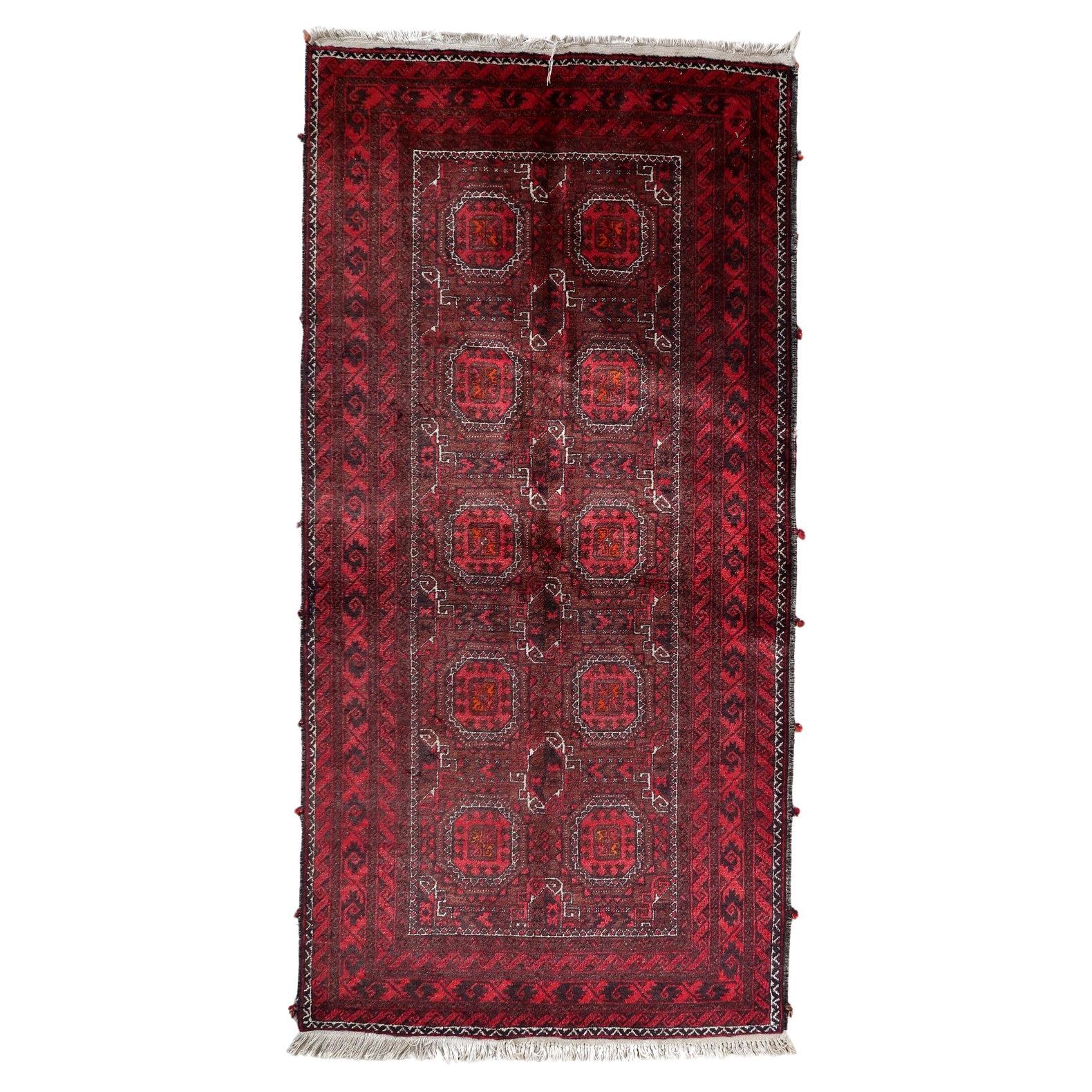 Full top view of the vintage Baluch runner rug showing the repetitive geometric pattern.

