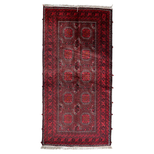 Full top view of the vintage Baluch runner rug showing the repetitive geometric pattern.

